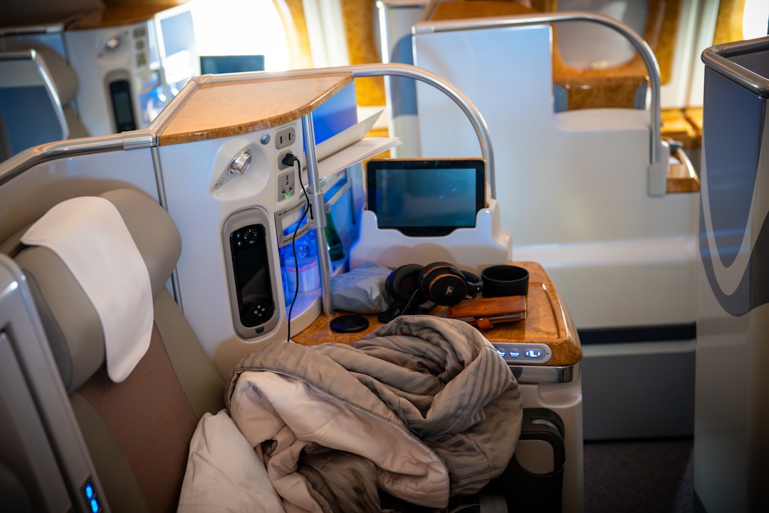 Luxurious airplane cabin seat with entertainment features.