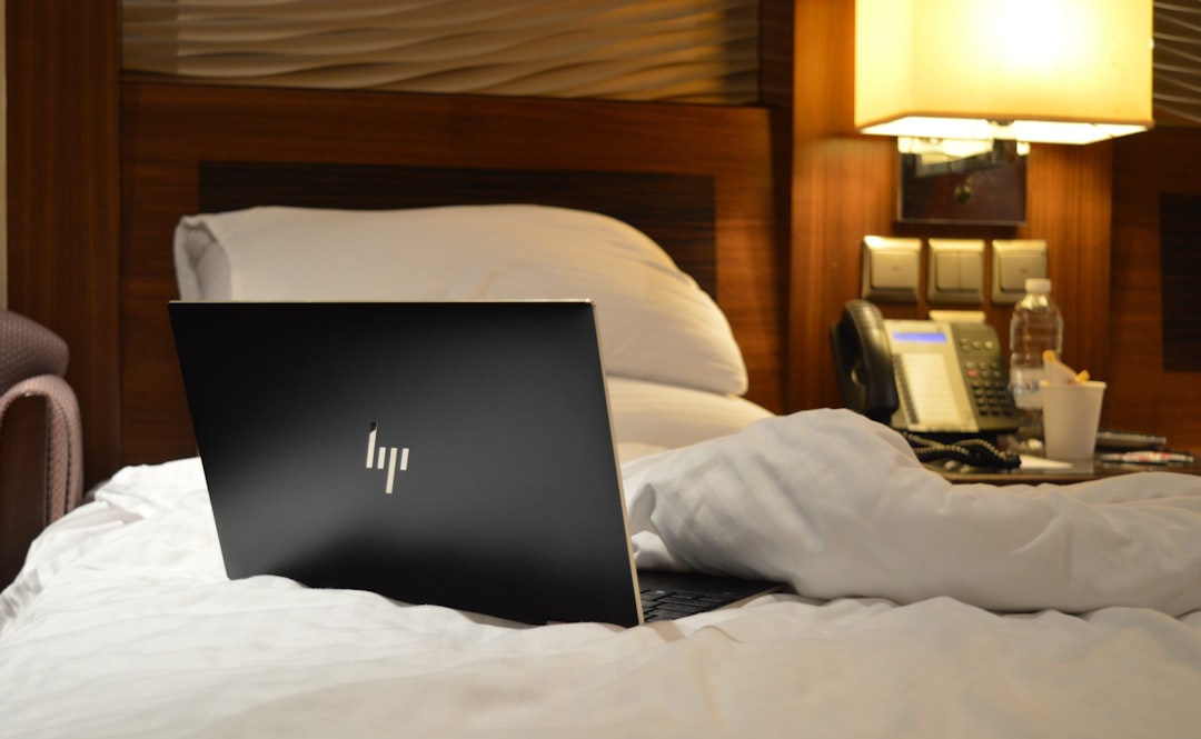 Macbook pro on white bed