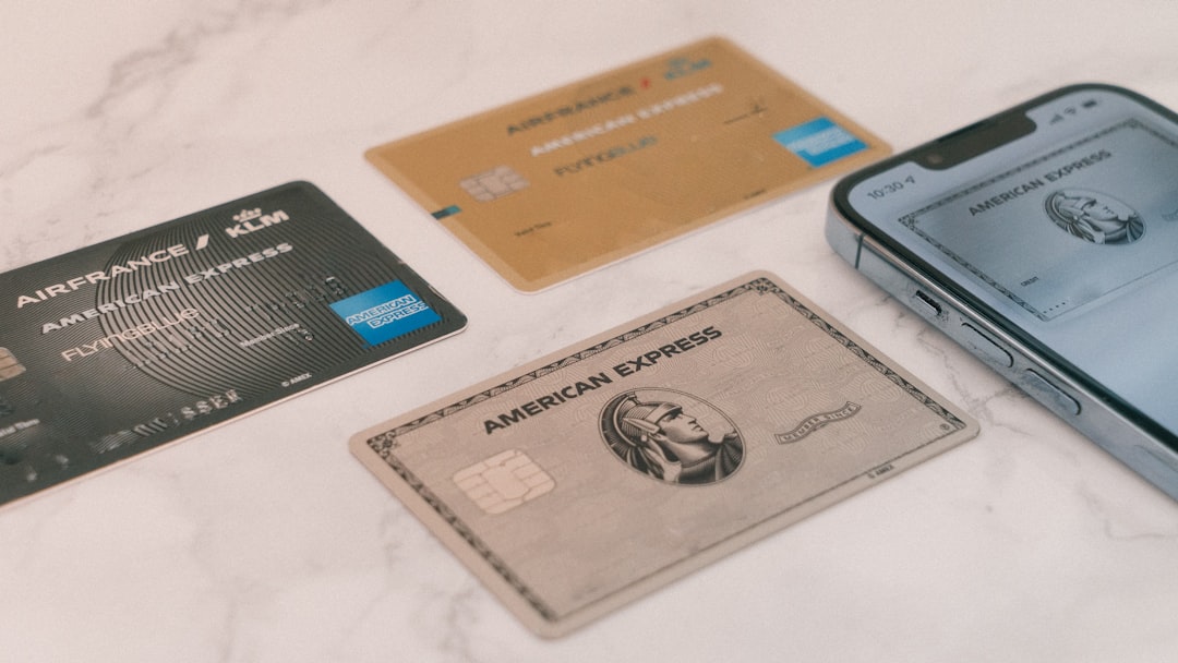 A group of credit cards sitting next to a cell phone